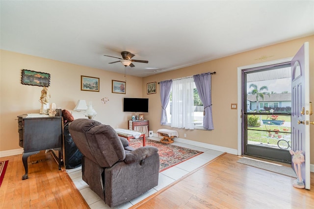 402 Cicero St NW, Port Charlotte, FL 33948 - living area with baseboards, light wood-style flooring, and a ceiling fan