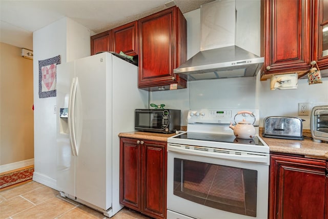 402 Cicero St NW, Port Charlotte, FL 33948 - kitchen featuring wall chimney range hood, reddish brown cabinets, and white appliances