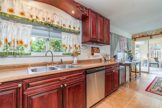 402 Cicero St NW, Port Charlotte, FL 33948 - kitchen with dishwasher, light countertops, a sink, and dark brown cabinets