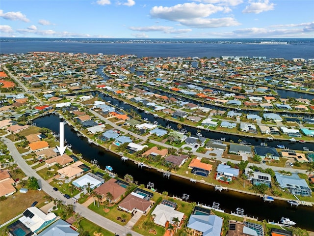 drone / aerial view featuring a residential view and a water view