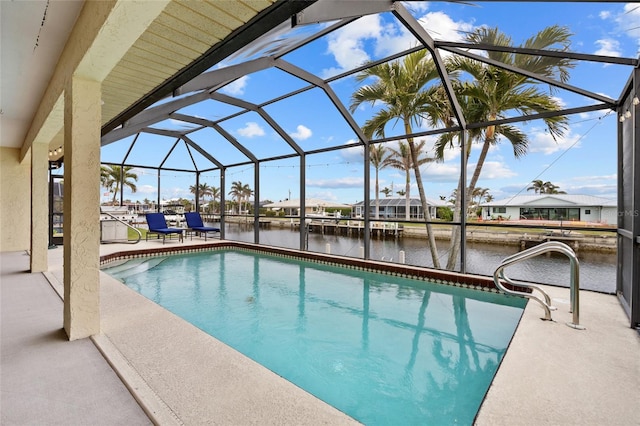 outdoor pool featuring a water view, glass enclosure, and a patio