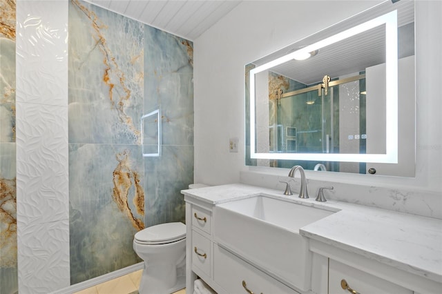 full bath with toilet, vanity, and a stall shower