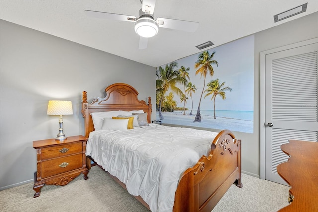 bedroom featuring baseboards, ceiling fan, and light colored carpet
