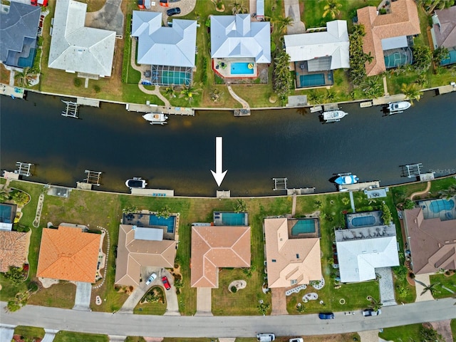 drone / aerial view with a water view and a residential view