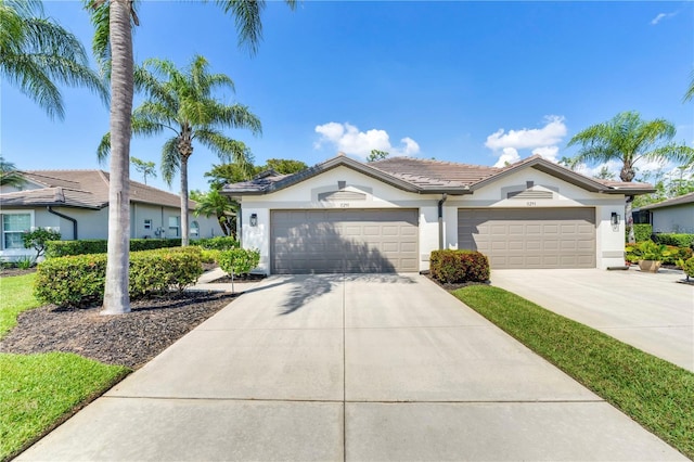 11291 Wine Palm Rd, Fort Myers, FL 33966 - view of front facade featuring stucco siding, driveway, and a garage