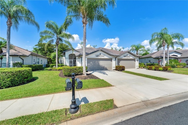 11291 Wine Palm Rd, Fort Myers, FL 33966 - mediterranean / spanish-style home featuring a front lawn, stucco siding, a garage, and concrete driveway