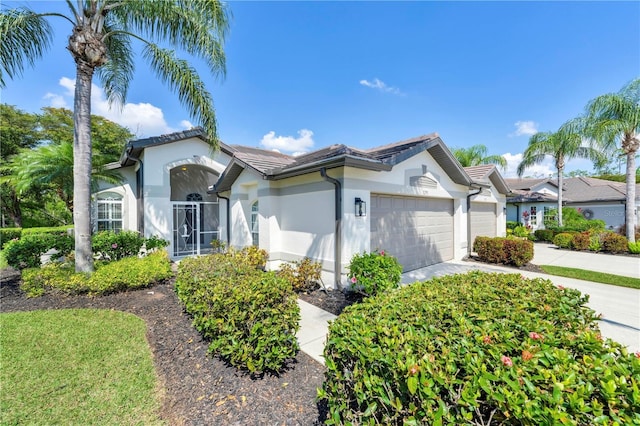 11291 Wine Palm Rd, Fort Myers, FL 33966 - view of front facade featuring stucco siding, a garage, a tiled roof, and concrete driveway
