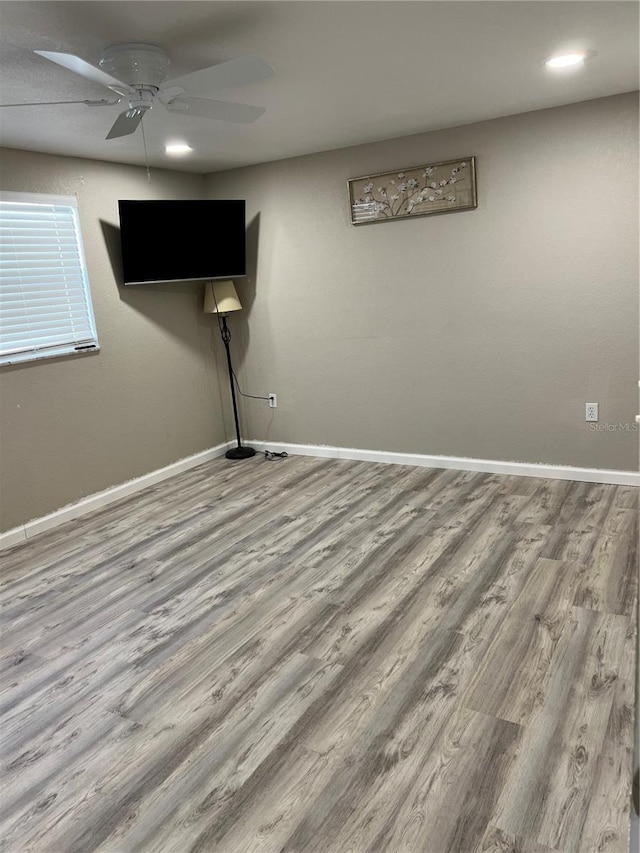 interior space with baseboards, ceiling fan, wood finished floors, and recessed lighting