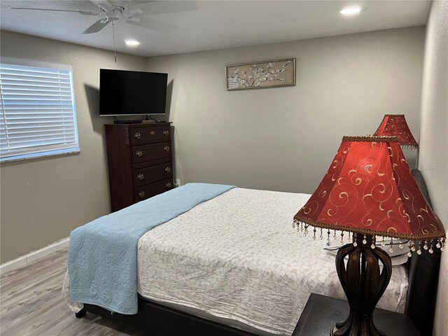 bedroom featuring recessed lighting, baseboards, ceiling fan, and wood finished floors