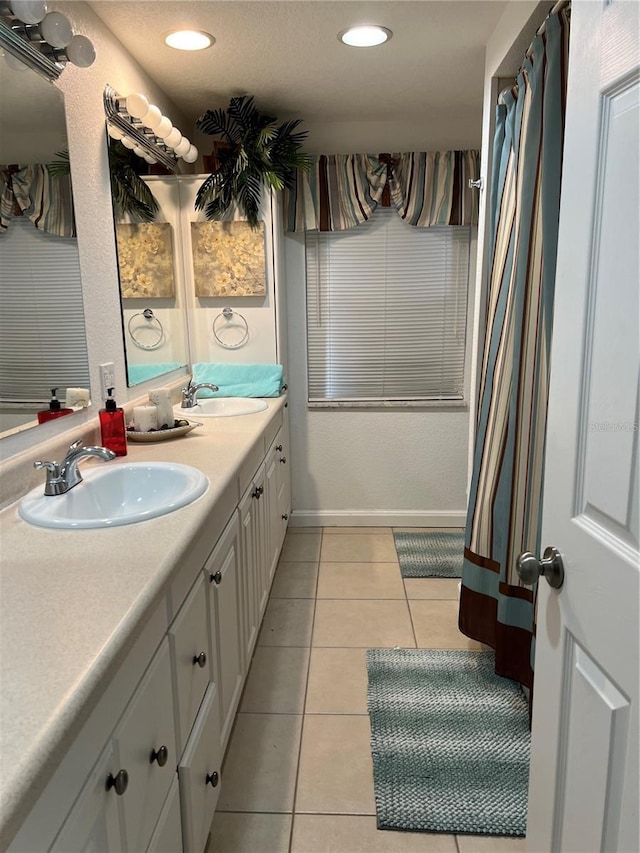 full bathroom with tile patterned floors, recessed lighting, double vanity, and a sink