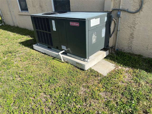 exterior details featuring cooling unit and stucco siding