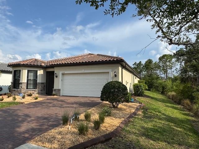 1263 Cicely Ct, North Port, FL 34289 - view of front of property with driveway, an attached garage, stucco siding, a tile roof, and a front lawn