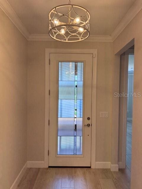 1263 Cicely Ct, North Port, FL 34289 - doorway with light wood-type flooring, a chandelier, crown molding, and baseboards