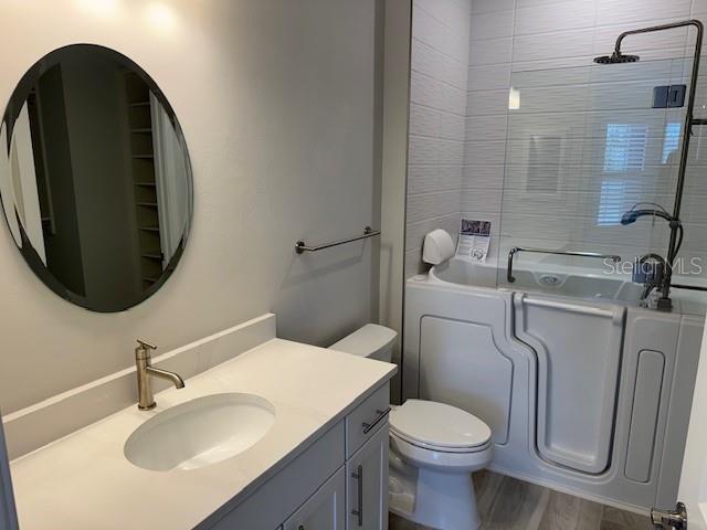 1263 Cicely Ct, North Port, FL 34289 - bathroom with vanity, toilet, and wood finished floors