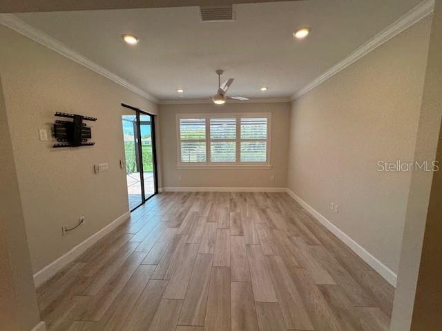 1263 Cicely Ct, North Port, FL 34289 - unfurnished room with a ceiling fan, light wood-style floors, baseboards, recessed lighting, and crown molding