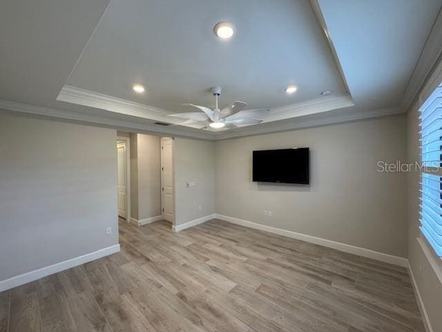 1263 Cicely Ct, North Port, FL 34289 - unfurnished room with a tray ceiling, ornamental molding, ceiling fan, baseboards, and light wood finished floors