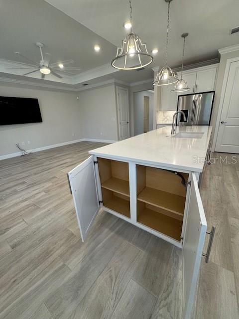 1263 Cicely Ct, North Port, FL 34289 - kitchen with stainless steel refrigerator with ice dispenser, open shelves, a sink, light wood-style flooring, and ceiling fan