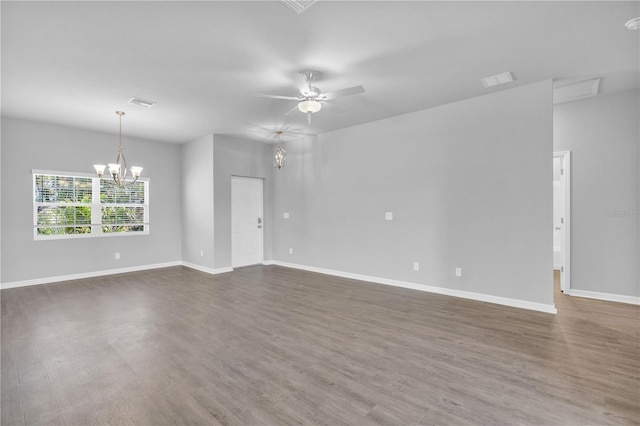20241 Lorette Ave, Port Charlotte, FL 33954 - unfurnished room featuring visible vents, ceiling fan with notable chandelier, baseboards, and dark wood finished floors