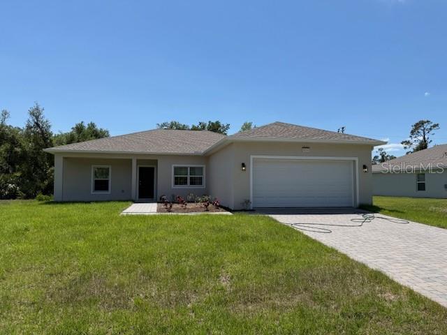 20241 Lorette Ave, Port Charlotte, FL 33954 - ranch-style house with a front yard, a garage, decorative driveway, and stucco siding