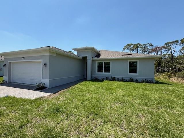 369 Biltmore St, Port Charlotte, FL 33953 - ranch-style house with a front yard, an attached garage, driveway, and stucco siding