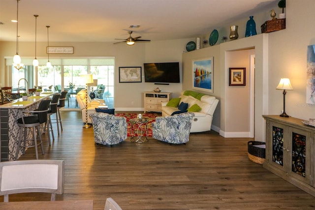 living area featuring dark wood finished floors, baseboards, a ceiling fan, and visible vents