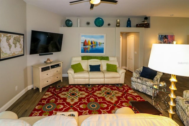 living area with baseboards, wood finished floors, and ceiling fan