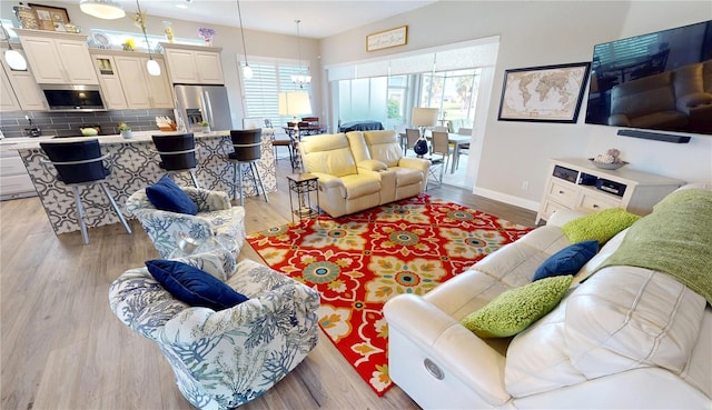 living area with light wood finished floors and baseboards