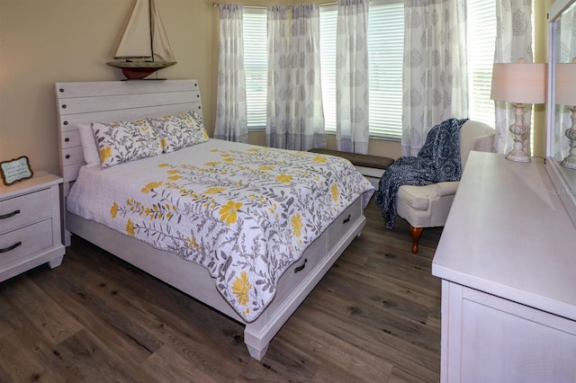 bedroom with dark wood finished floors