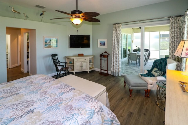 bedroom featuring access to exterior, visible vents, baseboards, a ceiling fan, and wood finished floors