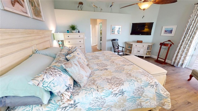 bedroom with baseboards, a ceiling fan, and wood finished floors