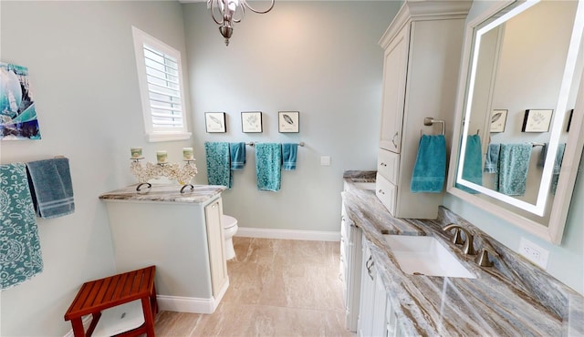 bathroom featuring marble finish floor, toilet, vanity, and baseboards