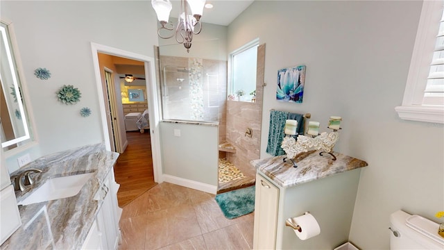 full bath with toilet, vanity, an inviting chandelier, ensuite bath, and a walk in shower