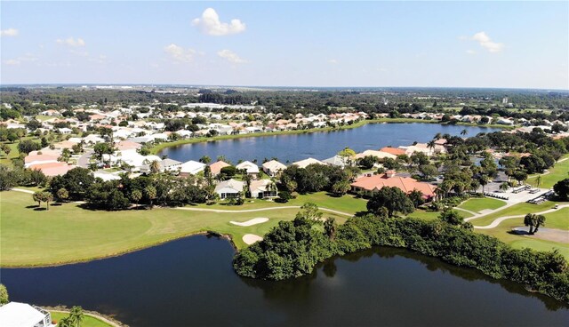 drone / aerial view with a residential view, a water view, and view of golf course