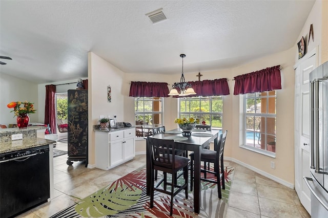 dining space featuring visible vents, baseboards, light tile patterned floors, a chandelier, and a textured ceiling