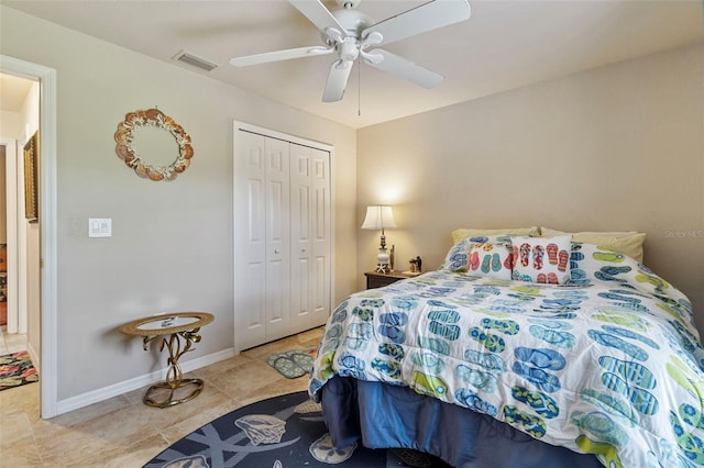 tiled bedroom with a closet, baseboards, ceiling fan, and visible vents