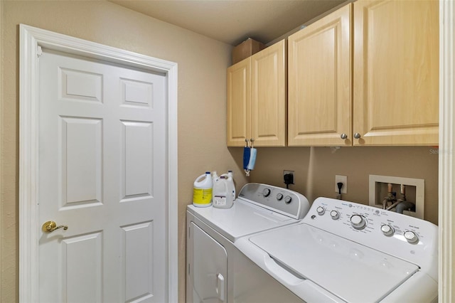 laundry area featuring washer and dryer and cabinet space