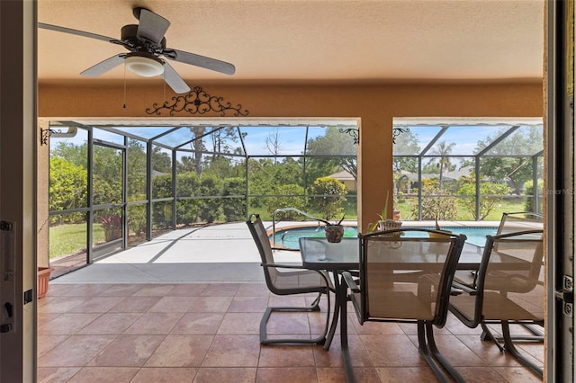sunroom featuring a ceiling fan and a wealth of natural light