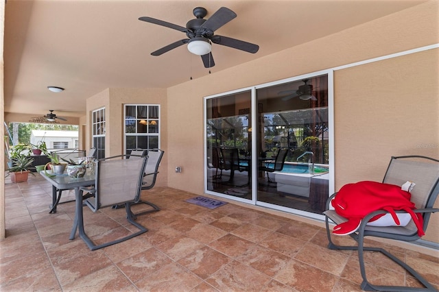 view of patio featuring outdoor dining area and a ceiling fan
