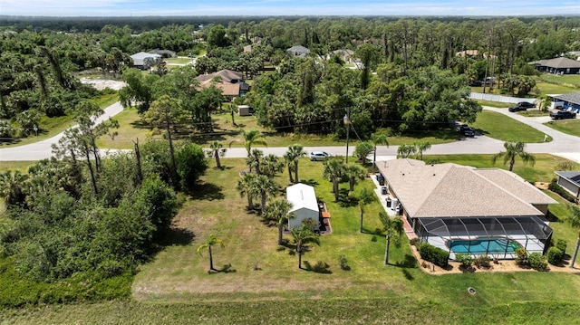 drone / aerial view with a wooded view