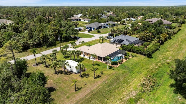 birds eye view of property with a view of trees
