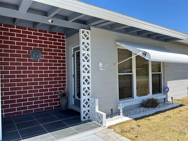 123 Poinsettia Cir NE, Port Charlotte, FL 33952 - entrance to property with brick siding and a security system