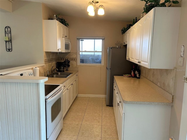 123 Poinsettia Cir NE, Port Charlotte, FL 33952 - kitchen featuring white appliances, a sink, decorative backsplash, and white cabinetry