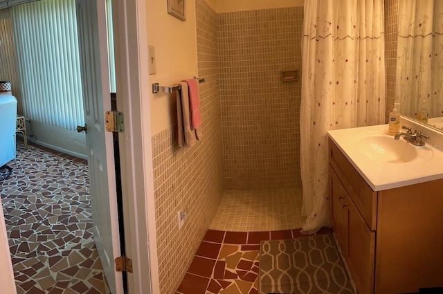 123 Poinsettia Cir NE, Port Charlotte, FL 33952 - bathroom with a tile shower, vanity, and tile patterned floors