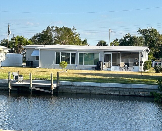 123 Poinsettia Cir NE, Port Charlotte, FL 33952 - back of house with a sunroom, a water view, central air condition unit, and stucco siding