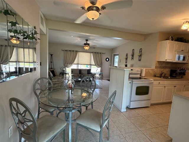 123 Poinsettia Cir NE, Port Charlotte, FL 33952 - dining space featuring ceiling fan, light tile patterned floors, and beamed ceiling