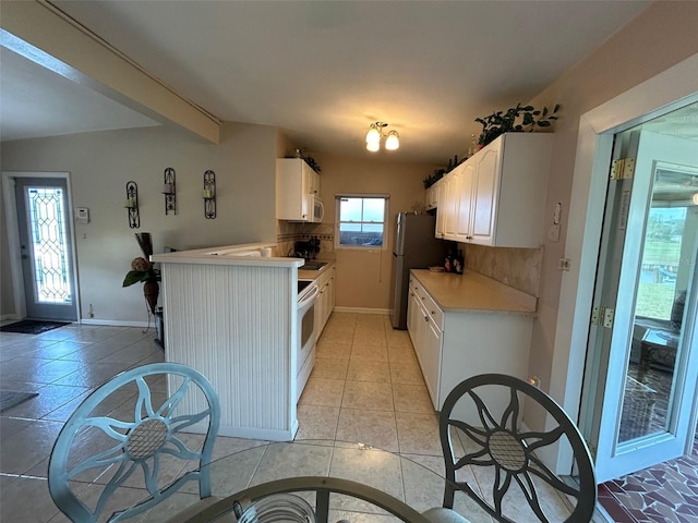 123 Poinsettia Cir NE, Port Charlotte, FL 33952 - kitchen featuring light countertops, white cabinets, baseboards, freestanding refrigerator, and white electric range oven