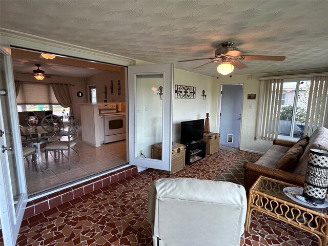 123 Poinsettia Cir NE, Port Charlotte, FL 33952 - living room featuring a ceiling fan, a textured ceiling, and baseboards