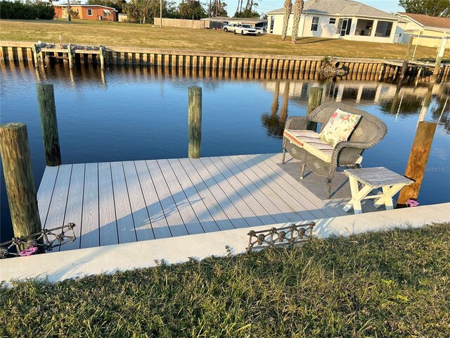 123 Poinsettia Cir NE, Port Charlotte, FL 33952 - dock area with a water view and a yard