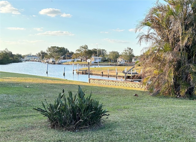 123 Poinsettia Cir NE, Port Charlotte, FL 33952 - view of green lawn featuring a dock and a water view