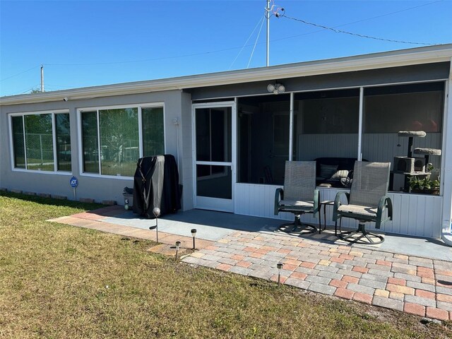 123 Poinsettia Cir NE, Port Charlotte, FL 33952 - rear view of house with a patio area, a sunroom, and a yard